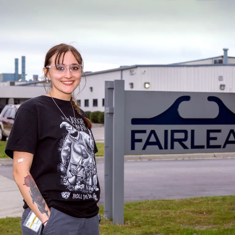 Woman standing in front of a sign