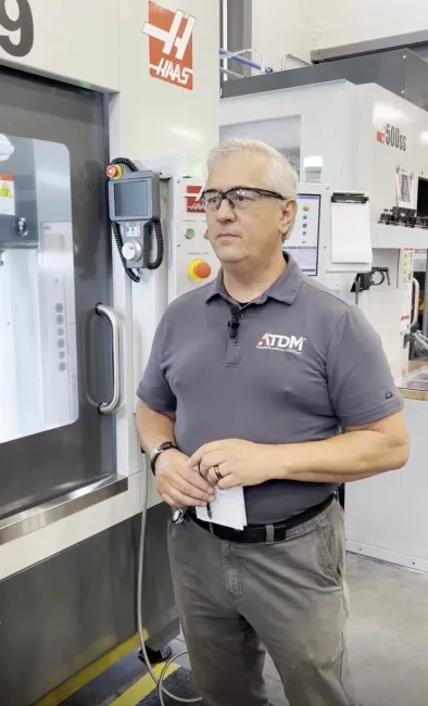 Man standing in front of CNC machine