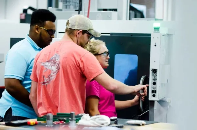 People using a CNC machine